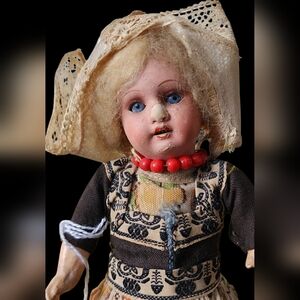 Antique Doll with Red Bead Necklace